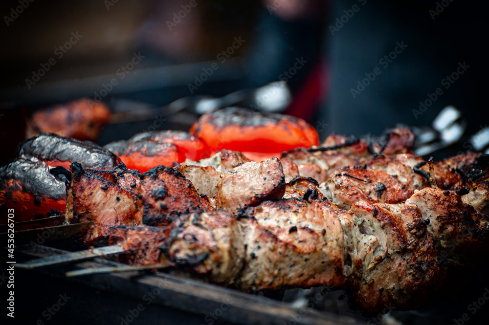 Fresh shish kebab on skewers is fried on the grill.