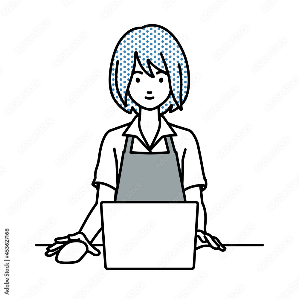 デスクで座ってPCを使っているカフェ店員の女性