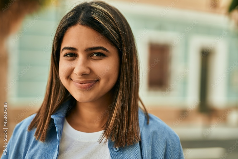 Young latin girl smiling happy standing at the city. Young latin girl smiling happy standing at the city.