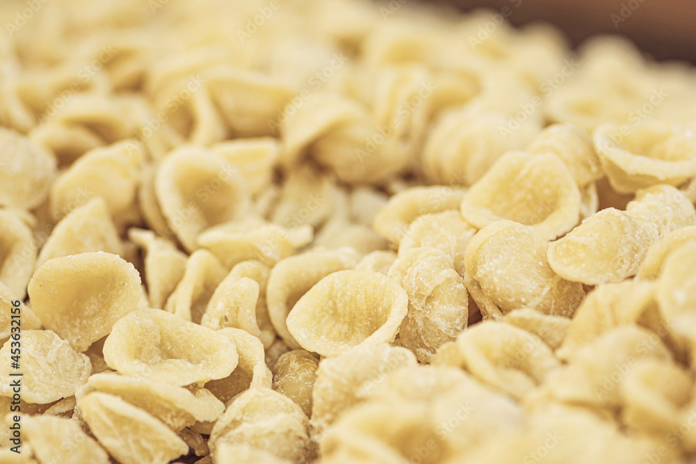 Fresh orecchiette or orecchietta, made with durum wheat and water, handmade pasta typical of Puglia or Apulia , a region of Southern Italy, close up Fresh orecchiette or orecchietta, made with durum wheat and water, handmade pasta typical of Puglia or Apulia , a region of Southern Italy, close up
