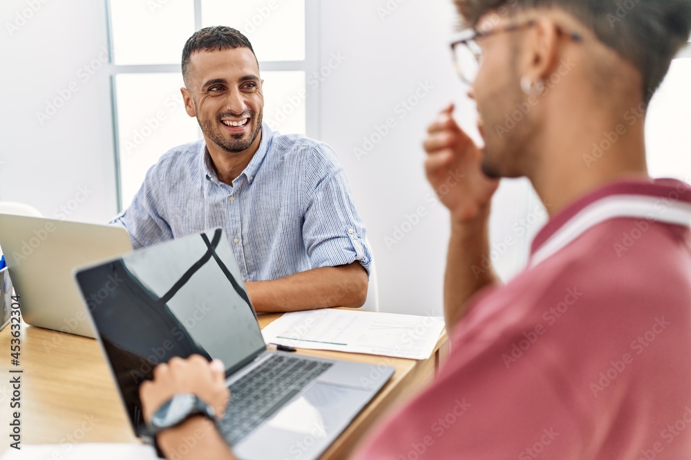 Two business workers smiling happy working at the office. Two business workers smiling happy working at the office.