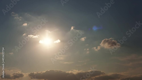 Sun fast moving down through clouds with rays and lens flare. Sunset timelapse. Awesome light and shadow landscape scene. Majestic cloudscape nature composition. Time lapse.