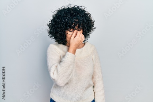 Young middle east woman wearing casual white tshirt tired rubbing nose and eyes feeling fatigue and headache. stress and frustration concept.