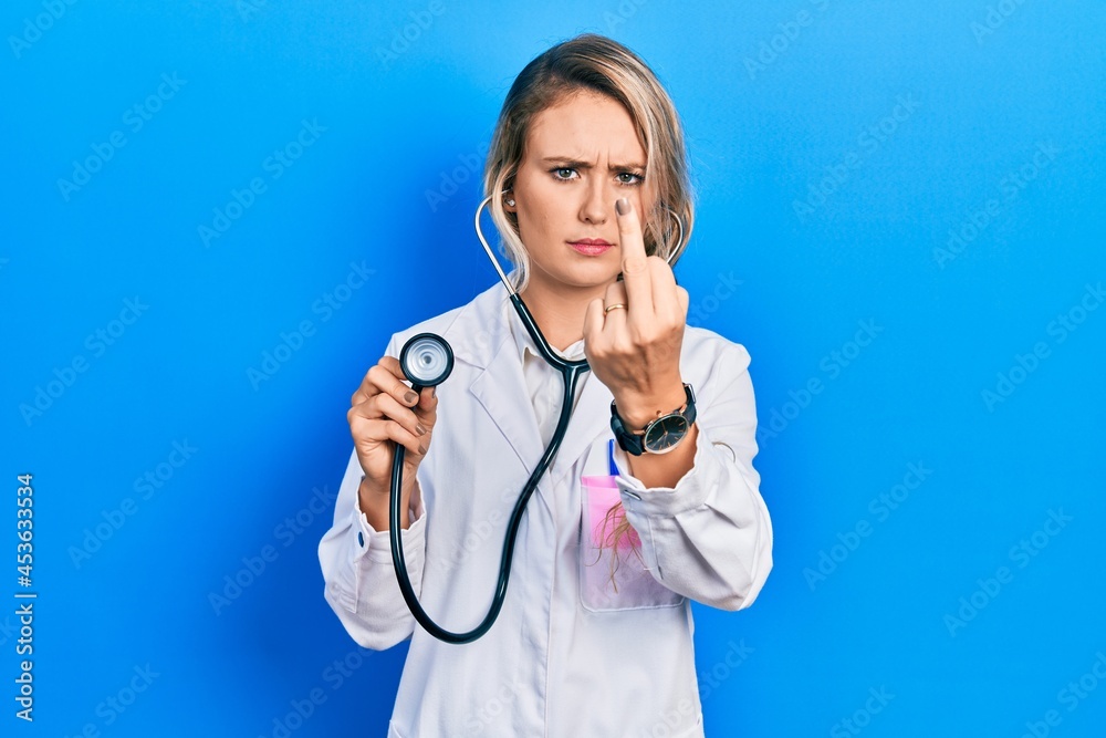 Beautiful Young Blonde Doctor Woman Holding Stethoscope Showing Middle 1856