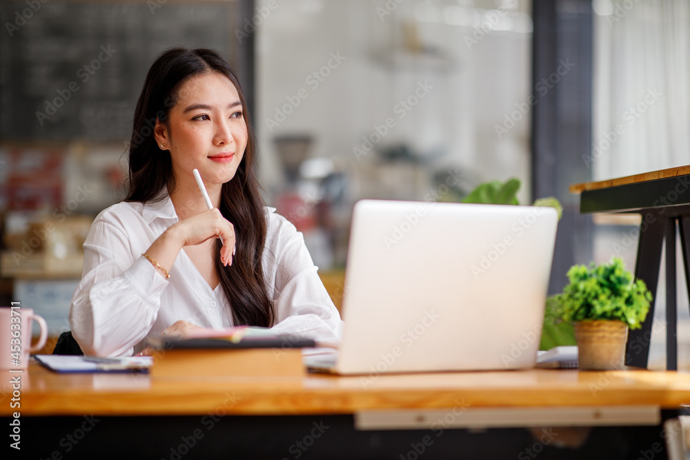 Portrait of smiling beautiful business asian woman with working in modern office desk using computer, Business people employee freelance online marketing e-commerce telemarketing concept. Portrait of smiling beautiful business asian woman with working in modern office desk using computer, Business people employee freelance online marketing e-commerce telemarketing concept.