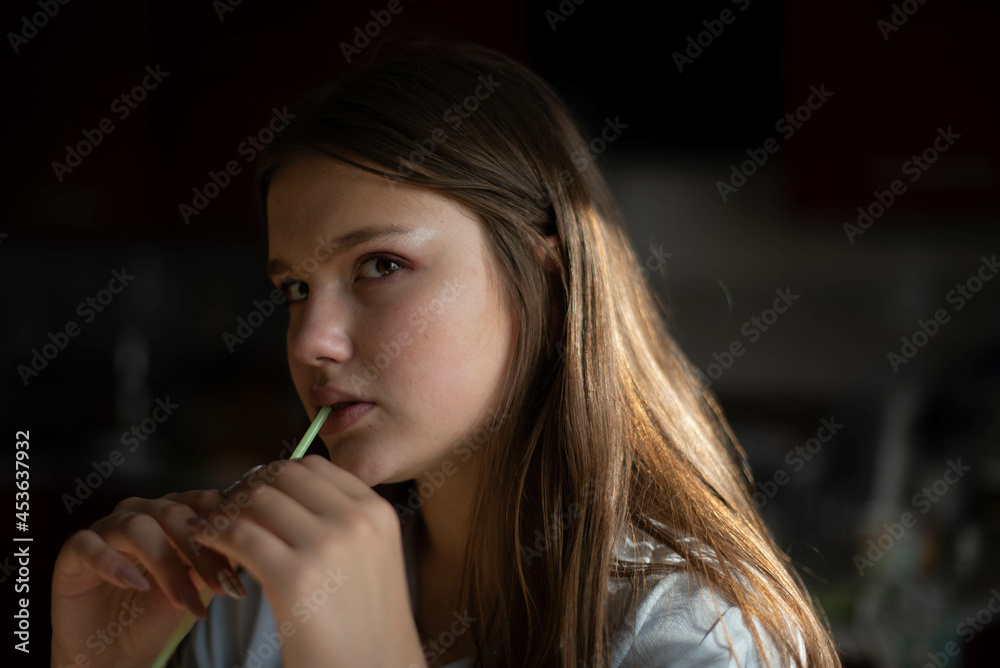 Fashion lifestyle image of pretty teenage young woman sitting in kitchen. Natural beauty. Fashion lifestyle image of pretty teenage young woman sitting in kitchen. Natural beauty.