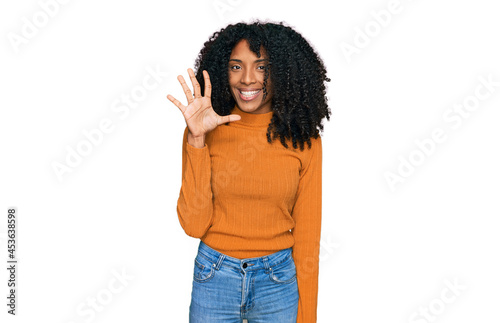 Young african american girl wearing casual clothes showing and pointing up with fingers number five while smiling confident and happy.