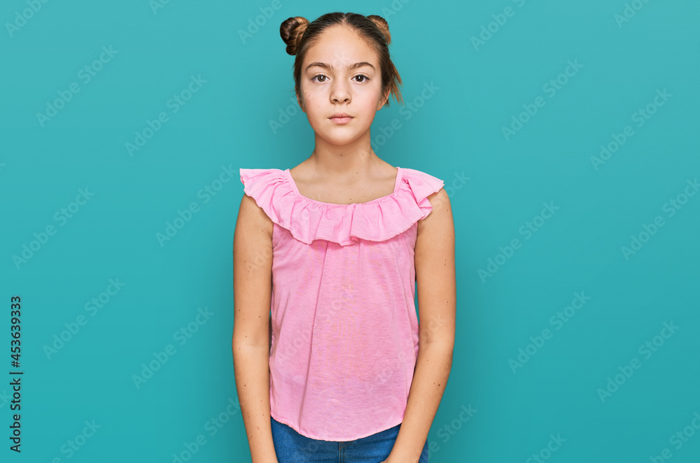 Beautiful brunette little girl wearing summer pink shirt with serious expression on face. simple and natural looking at the camera. Beautiful brunette little girl wearing summer pink shirt with serious expression on face. simple and natural looking at the camera.
