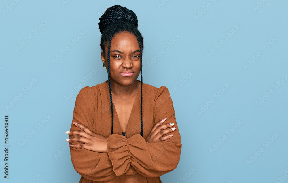 Young african american woman wearing casual clothes skeptic and nervous, disapproving expression on face with crossed arms. negative person. Young african american woman wearing casual clothes skeptic and nervous, disapproving expression on face with crossed arms. negative person.