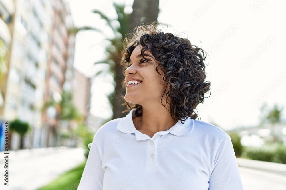 Young latin girl smiling happy standing at the city. Young latin girl smiling happy standing at the city.