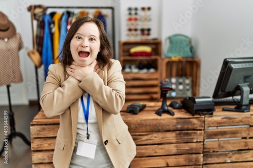 Young down syndrome woman working as manager at retail boutique shouting and suffocate because painful strangle. health problem. asphyxiate and suicide concept.