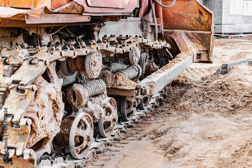 Bulldozer crawler machine close-up. Powerful bulldozer tracks. Construction machinery for land leveling. Construction heavy machinery.