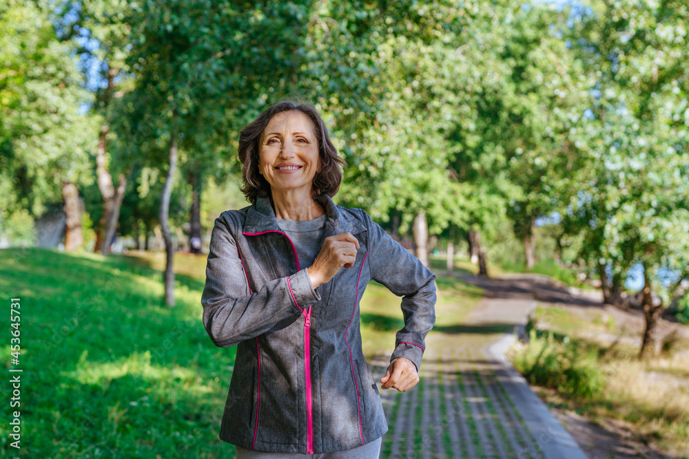 Happy mature woman jogging in the park outdoor Happy mature woman jogging in the park outdoor