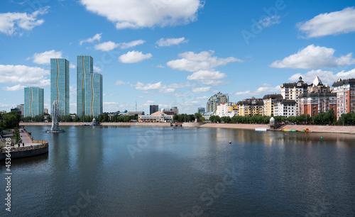 Nur-Sultan, Kazakhstan, July 2021. View from the Atyrau bridge to the Ishim River and tall buildings. High quality photo