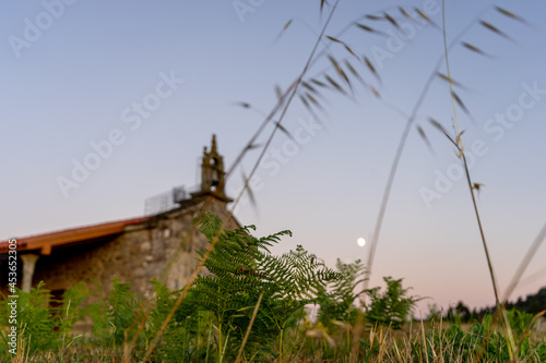 unfocused rural church with almost full moon photo