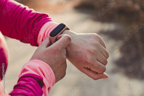 CLose up of sporty woman using fitness tracker or heart rate monitor