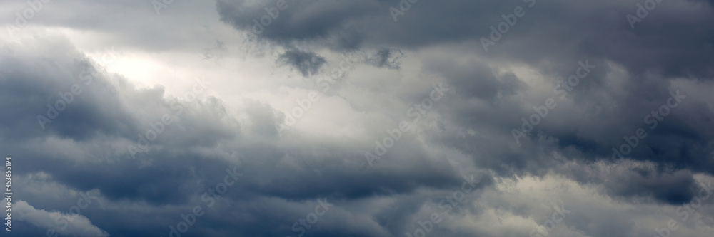 Panoramic banner of dark gray clouds sky.
