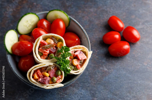 Organic vegan vegetable wraps. Organic vegan vegetable wraps filled with corn, red beat, tomatoes, beans in a bowl on a table top.