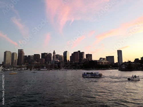 Colorful sunset over Boston skyline from the sea