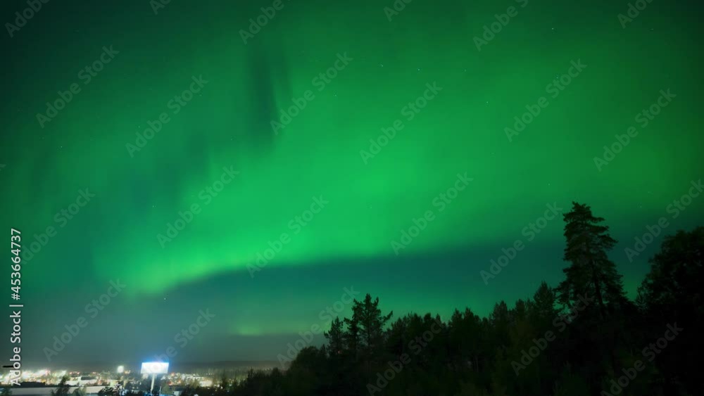 4K timelapse of aurora borealis in northern Sweden with dancing green and purple light beside a city with street lights 4K timelapse of aurora borealis in northern Sweden with dancing green and purple light beside a city with street lights