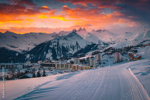 Popular alpine ski resort with colorful sunrise, La Toussuire, France