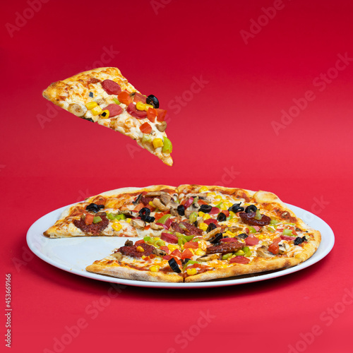 Assorted Pizza and pizza slice lifted levitating red background