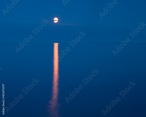 Moon track on the water. Sea evening landscape. The concept of minimalism.