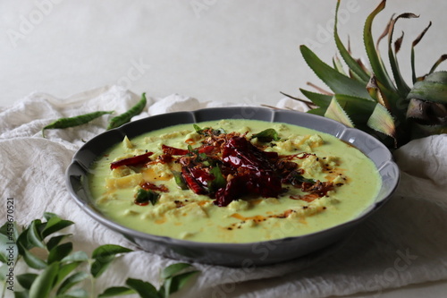 Pineapple pachadi. A yogurt based sweet and spicy curry made with pineapple, coconut, mustard seeds and curd. A side dish for Kerala meals photo