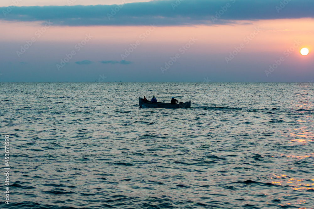 A fisherman boat on the Black sea at the sundawn