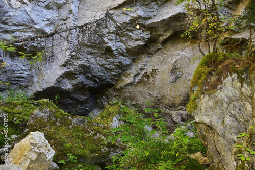 Arch on the steep wall of the karst hole Wolf pit