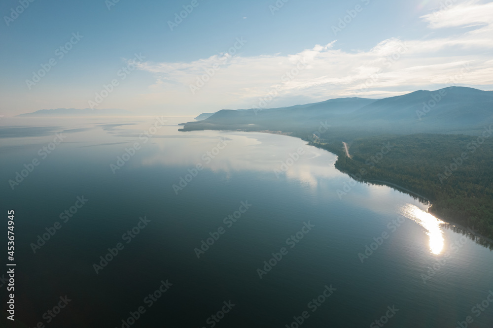 Fantastic panorama of Lake Baikal at sunset is a rift lake located in southern Siberia, Russia. Baikal lake summer landscape view. Drone's Eye View.