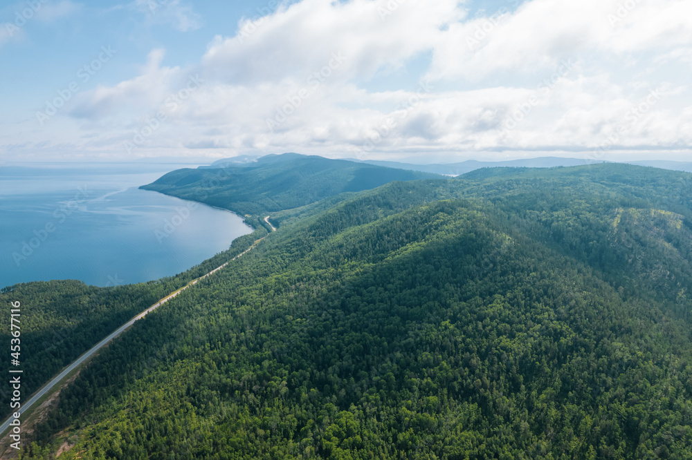 Summertime imagery of Lake Baikal is a rift lake located in southern Siberia, Russia Baikal lake summer landscape view from a cliff near Grandma's Bay. Drone's Eye View.