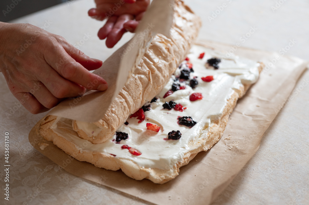 Woman hands cooking meringue roll Woman hands cooking meringue roll