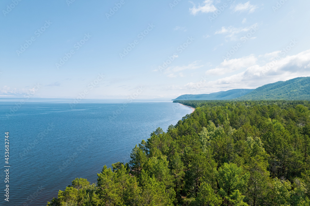 Summertime imagery of Lake Baikal is a rift lake located in southern Siberia, Russia Baikal lake summer landscape view from a cliff near Grandma's Bay. Drone's Eye View.