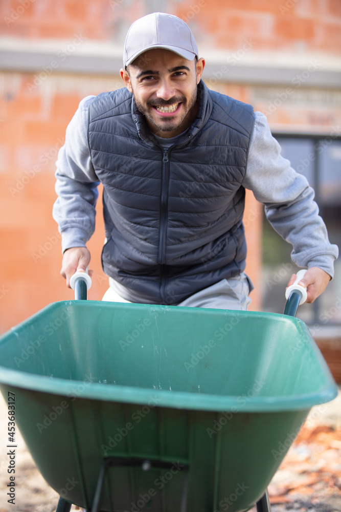man with a wheelbarrow at the construction site