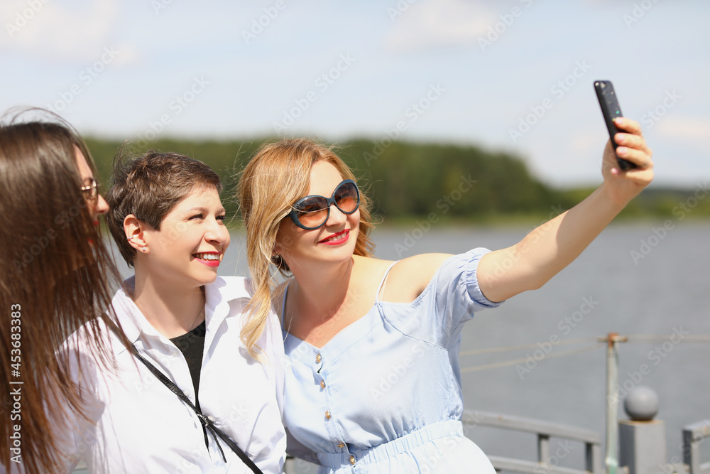 Women on the river are photographed on the phone