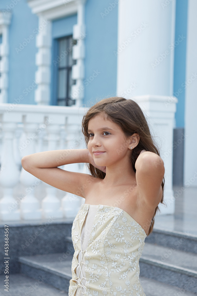 Happy little Girl in a beautiful dress.