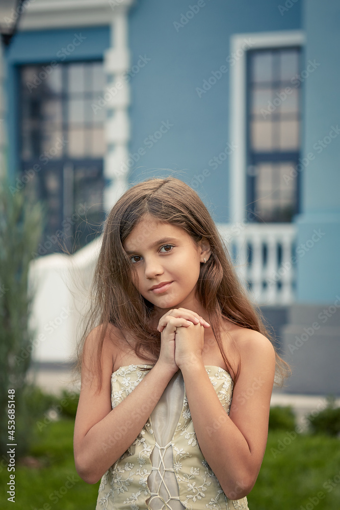 Happy little Girl in a beautiful dress.