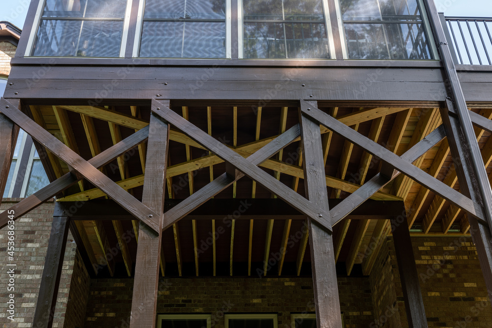 Detail of wooden porch architecture with X braces structure. Building addition concept. Detail of wooden porch architecture with X braces structure. Building addition concept.