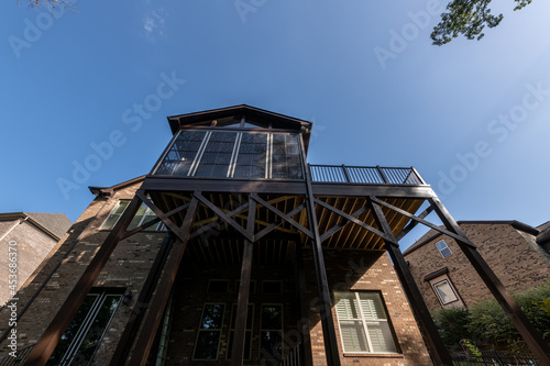 Wooden porch architecture with covered structure with gable roof. Building addition concept.