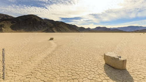 Time lapse of the clouds above the famous moving rocks on the Race Track dry lake in Death Valley photo