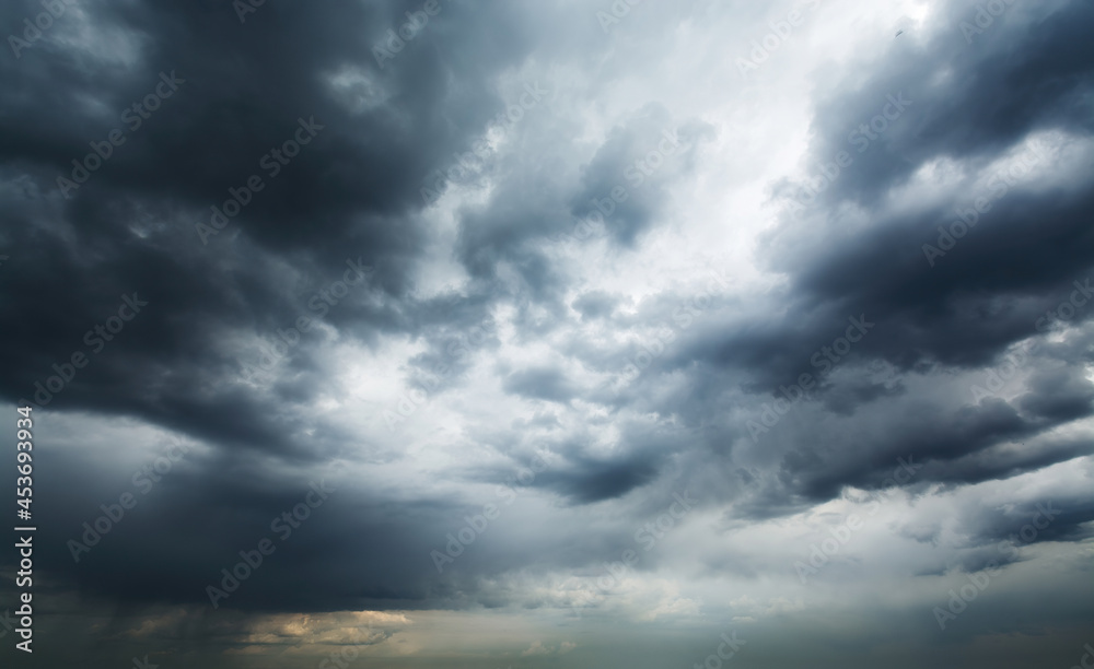 Picturesque aerial view of stormy clouds dramatically moving across the sky and gradually covering it until total darkness.