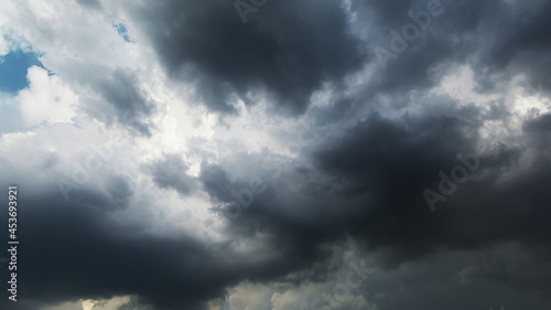 Picturesque view of black stormy clouds moving heavily on the dark sky creating dangerous and dramatic atmosphere.