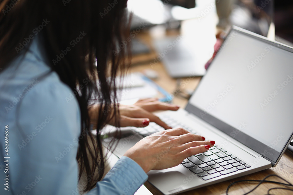 Woman sitting at the table and working at laptop Woman sitting at the table and working at laptop