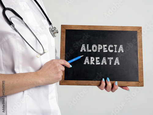 Healthcare concept meaning ALOPECIA AREATA with sign on the chalkboard photo