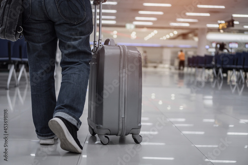 Traveler passenger hold luggage at terminal airport or transit flight with suitcase in journey vacation holiday at arrival international, No people in transportation during covid19 virus pandemic