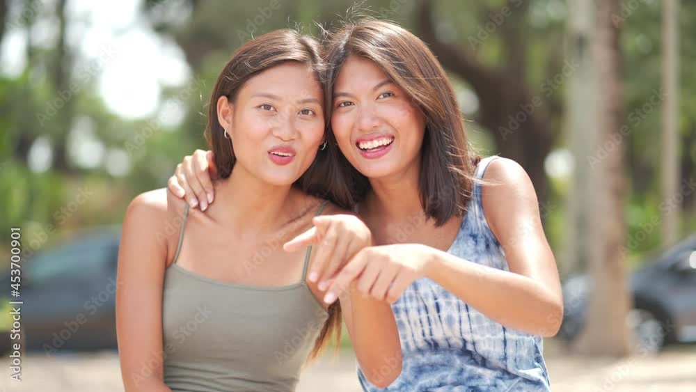 4K Portrait of Attractive Asian woman sibling sister family sitting on the beach with smiling face. Beautiful female friendship relax and enjoy outdoor activity lifestyle on summer holiday vacation. 4K Portrait of Attractive Asian woman sibling sister family sitting on the beach with smiling face. Beautiful female friendship relax and enjoy outdoor activity lifestyle on summer holiday vacation.