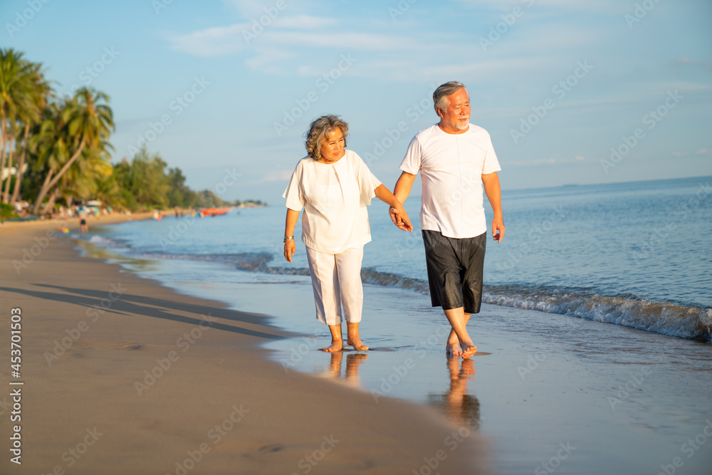 Family On Summer Beach Vacation, healthy older couple running on sea beach, Concept for .caring for the elderly, Caregiving to older persons and relations of the family to support elderly state