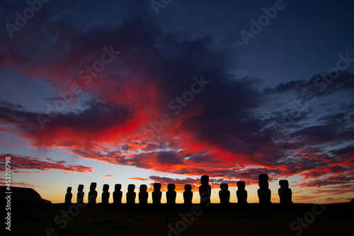 Dramatic colorful sunrise over Moai stone sculptures at Ahu Tongariki, Easter island, Chile.
