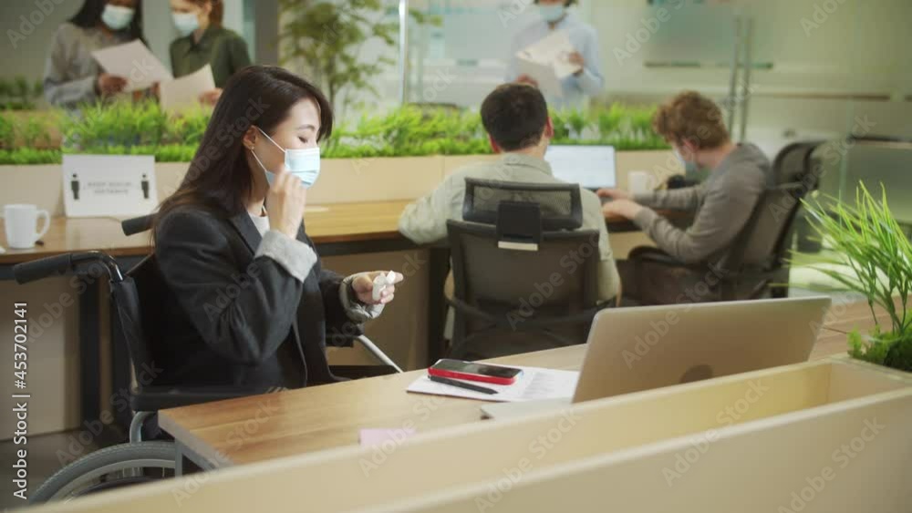 An attractive businesswoman is telephoning someone during working An attractive businesswoman is telephoning someone during working